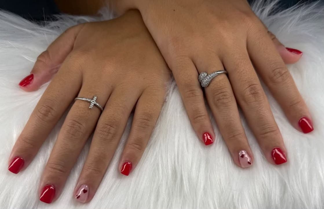 Manicure rossa con dettaglio cuori